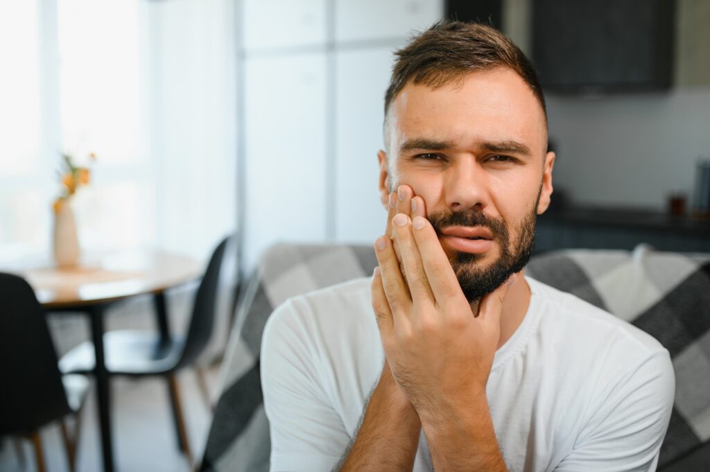 Patient with tooth sensitivity receiving dental evaluation at Orchard Family Dental in Leduc