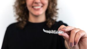 Patient wearing clear Invisalign aligners smiling at Orchard Family Dental in Leduc